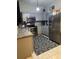 Modern kitchen with stainless steel appliances, granite countertops, and gray cabinets at 306 Clermont Dr, Kissimmee, FL 34759