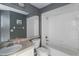 This gray bathroom has a shower over tub, a large mirror, and a granite-look countertop at 3228 Fairfield Dr, Kissimmee, FL 34743