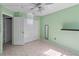 This light green bedroom has a large closet, neutral tile floors, and a floating shelf at 3228 Fairfield Dr, Kissimmee, FL 34743