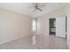 Open bedroom with ensuite bathroom, ceiling fan, and natural light at 3228 Fairfield Dr, Kissimmee, FL 34743