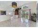 Open dining area featuring modern lighting, tile flooring, and glass sliding door at 3228 Fairfield Dr, Kissimmee, FL 34743