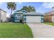 Charming single-story home featuring a well-manicured lawn and attached two car garage at 3228 Fairfield Dr, Kissimmee, FL 34743