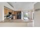 Bright kitchen featuring granite counters, wood cabinets, tile backsplash and modern, black appliances at 3228 Fairfield Dr, Kissimmee, FL 34743