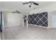 Spacious living room featuring tile floors, neutral paint, and a ceiling fan at 3228 Fairfield Dr, Kissimmee, FL 34743