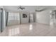 Open-concept living room boasting tiled floors, ample natural light and ceiling fans at 3228 Fairfield Dr, Kissimmee, FL 34743