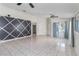 Bright living area highlighting tile flooring, neutral walls, ceiling fans, and a window at 3228 Fairfield Dr, Kissimmee, FL 34743