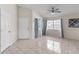 Bright living room featuring neutral walls, tile flooring, windows, and a ceiling fan at 3228 Fairfield Dr, Kissimmee, FL 34743