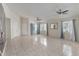 Large living space with tiled flooring, several windows, and two ceiling fans at 3228 Fairfield Dr, Kissimmee, FL 34743