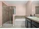 Bathroom featuring a glass enclosed shower, soaking tub, and vanity at 3797 Briarwood Estates Cir, St Cloud, FL 34772