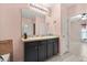 Bathroom featuring double sinks, dark wood cabinets, and decorative mirror lighting at 3797 Briarwood Estates Cir, St Cloud, FL 34772