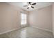 Bedroom featuring sleek, tiled floors, ceiling fan, and a window providing natural light at 3797 Briarwood Estates Cir, St Cloud, FL 34772