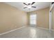 Bedroom featuring tile floors, a ceiling fan, and a closet with sliding mirrored doors at 3797 Briarwood Estates Cir, St Cloud, FL 34772