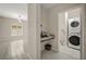 View of a hallway with built-in desk and laundry closet with stacked washer and dryer at 3797 Briarwood Estates Cir, St Cloud, FL 34772