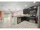 Open-concept kitchen featuring black cabinetry, granite countertops, and stainless steel appliances at 3797 Briarwood Estates Cir, St Cloud, FL 34772