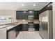 Beautiful kitchen showcasing granite countertops, stainless appliances, and sleek black cabinetry at 3797 Briarwood Estates Cir, St Cloud, FL 34772