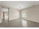 Bright living room features tile floors, neutral paint, and a view into a dining area at 3797 Briarwood Estates Cir, St Cloud, FL 34772