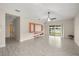 A spacious living room featuring neutral walls, tile floors, modern fixtures, and a view of the backyard at 3797 Briarwood Estates Cir, St Cloud, FL 34772