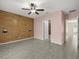 Spacious bedroom featuring tiled floors and a decorative wood-paneled wall at 3797 Briarwood Estates Cir, St Cloud, FL 34772