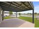 Covered patio offers views of the backyard, white fenced-in yard and above ground pool at 3797 Briarwood Estates Cir, St Cloud, FL 34772