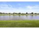 Serene water view from property overlooking lush green landscape and a tranquil pond at 3797 Briarwood Estates Cir, St Cloud, FL 34772