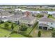Aerial backyard view featuring a playset and patio area, surrounded by a black fence and landscaping at 3853 Cortland Dr, Davenport, FL 33837