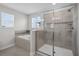 Elegant bathroom with a glass-enclosed shower, a separate bathtub, and a bright window at 3853 Cortland Dr, Davenport, FL 33837