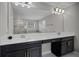 Bright bathroom featuring a double sink vanity, a large mirror, and modern fixtures, plus a separate tub and shower at 3853 Cortland Dr, Davenport, FL 33837