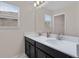 Bright bathroom featuring double sinks, a large mirror, and modern fixtures for a clean, functional space at 3853 Cortland Dr, Davenport, FL 33837