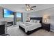 Modern bedroom featuring an electric fireplace, TV, ceiling fan, and soft gray color scheme at 3853 Cortland Dr, Davenport, FL 33837
