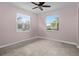 Comfortable bedroom featuring tile floors, a ceiling fan, and natural light from two windows at 3853 Cortland Dr, Davenport, FL 33837