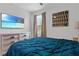 Serene bedroom with a decorative bed, large TV, and soft natural light creating a relaxing and inviting atmosphere at 3853 Cortland Dr, Davenport, FL 33837