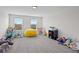 Spacious bonus room with neutral walls, large windows, and ample space for recreational activities at 3853 Cortland Dr, Davenport, FL 33837