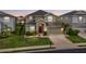 Attractive two-story home with a well-kept lawn, charming front entrance, and two car garage at 3853 Cortland Dr, Davenport, FL 33837