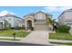 Beautiful two-story home with a well-maintained lawn, a charming front entrance, and two car garage at 3853 Cortland Dr, Davenport, FL 33837