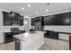 Modern kitchen featuring black cabinets, stainless steel appliances, a kitchen island, and tile floors at 3853 Cortland Dr, Davenport, FL 33837