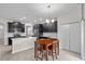 Modern eat-in kitchen featuring black cabinets, stainless steel appliances, and an island at 3853 Cortland Dr, Davenport, FL 33837