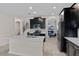 Modern kitchen featuring black cabinets, stainless steel appliances, a kitchen island, and tile floors at 3853 Cortland Dr, Davenport, FL 33837