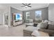Relaxing living area showcasing a plush sectional, media center, and natural light from the sliding glass door to the patio at 3853 Cortland Dr, Davenport, FL 33837