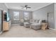 Comfortable living room with a large sectional sofa, ceiling fan, and neutral color palette, perfect for relaxation at 3853 Cortland Dr, Davenport, FL 33837