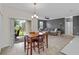 Open floor plan with dining area, sliding glass doors and a large living room with a gray couch at 3853 Cortland Dr, Davenport, FL 33837