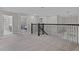 Spacious loft area with soft carpeting, black railings, and bright lighting, perfect for relaxation at 3853 Cortland Dr, Davenport, FL 33837