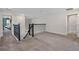 Inviting loft area with soft carpeting, black railings, and bright lighting, perfect for leisure at 3853 Cortland Dr, Davenport, FL 33837
