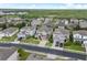 Aerial neighborhood view of houses with well-maintained landscaping and a community lake at 3853 Cortland Dr, Davenport, FL 33837