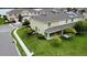 Aerial view of a backyard with a covered patio, showcasing green lawn and nearby lake at 403 Arbor Lakes Dr, Davenport, FL 33896
