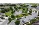 Aerial view of the community, lush landscaping, parking, and the exteriors of residential homes at 403 Arbor Lakes Dr, Davenport, FL 33896