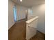 Upstairs hallway with white walls, brown carpet and access to rooms in a modern residential home at 403 Arbor Lakes Dr, Davenport, FL 33896