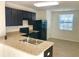 Well-lit kitchen featuring dark cabinets, updated appliances, and a functional design with an open view at 403 Arbor Lakes Dr, Davenport, FL 33896