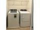 Functional laundry area featuring modern washer and dryer units and wire rack shelving above at 403 Arbor Lakes Dr, Davenport, FL 33896