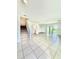 Spacious living room features tile flooring, natural light, and an open layout with stairs and access to the back patio at 403 Arbor Lakes Dr, Davenport, FL 33896
