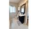Bathroom featuring a black vanity with solid surface top, tile floors, and great natural light from the window at 4151 Nelson Rd, Lake Wales, FL 33898